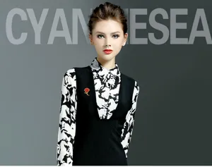 Detailed shot of a red carnation brooch worn on a chic black vest, elegant accessory style.