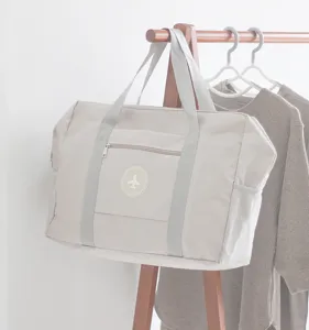 Portable travel duffel bag for luggage organization, waterproof garment storage tote for trips.