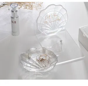 Iridescent glass shell jewelry dish detail, elegant Nordic style for rings and earrings.