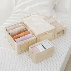 Set di scatole porta abiti in tessuto beige per organizzazione armadio, vista principale.
