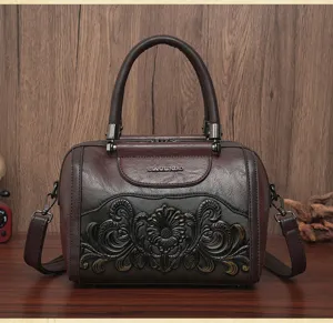 Vintage embossed leather shoulder bag detail, dark brown retro handbag with metal hardware.