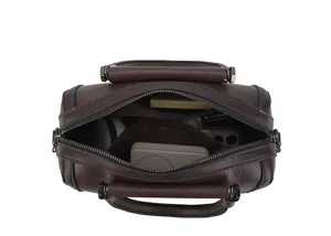 Dark brown leather boston handbag interior detail view showing spacious storage compartments.