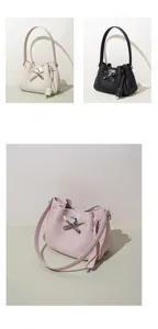 Elegant leather bucket bag with metal lock closure, versatile shoulder and crossbody design.
