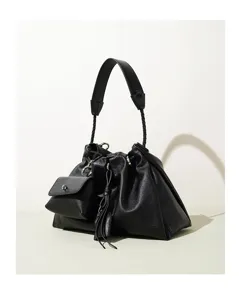 Detailed view of the black pleated cloud shoulder bag with braided strap and pouch.
