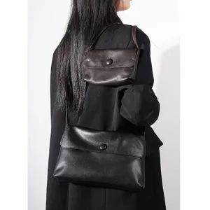 Premium black genuine leather shoulder bag detail, stylish women's crossbody purse design.