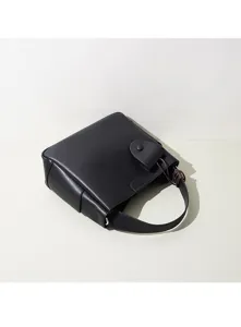 Minimalist black leather bucket bag, retro design for women's daily commuting and casual wear.