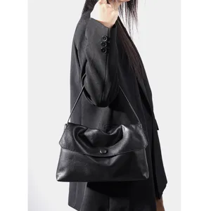 Elegant black leather handbag for women, minimalist style shoulder and crossbody bag.