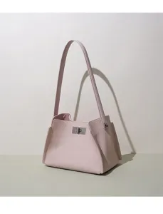 Close-up view of the pink leather shoulder bag showcasing delicate metal lock detail.