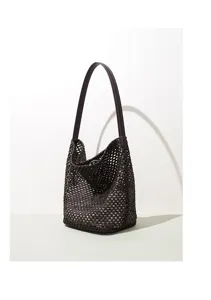 Detail view of the dark brown woven leather bucket bag, showcasing exquisite craftsmanship.