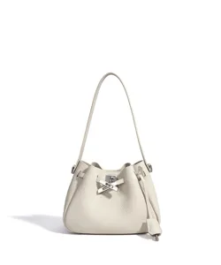 Close-up of leather bucket bag detail showing soft texture and refined metal lock hardware.