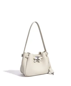 Beige leather bucket bag detail showing pebbled texture and unique silver metal lock closure.