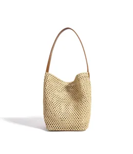 Woven straw bucket bag for women, summer beach shoulder bag with brown leather strap.