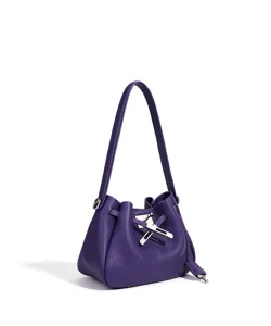 Purple leather bucket bag detail featuring chic metal clasp closure and elegant shoulder strap.