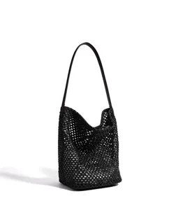 Close up detail of black woven mesh shoulder bucket bag, perfect summer beach accessory.