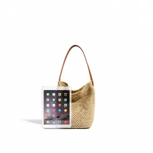 Detailed view of the woven straw beach hobo bag with leather strap, summer vacation handbag.