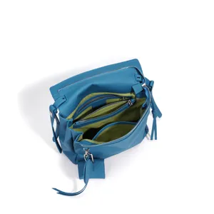 Blue leather shoulder bag top view showing interior compartments and multiple zipper pockets.