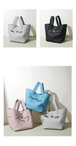 Detailed view of premium genuine leather top handle tote bag with stylish metal lock closure.