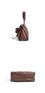 Minimalist brown leather shoulder bag with braided handle and slouchy cloud pouch design.
