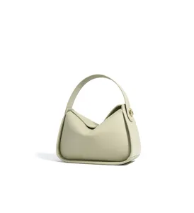 Detalle de bolso de hombro de cuero minimalista, asa curva elegante y textura lisa hoy.