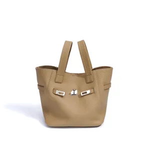 Detailed view of genuine leather bucket handbag in khaki with metal turn-lock closure.