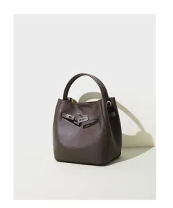 Dark brown leather bucket bag detail, featuring metal turn-lock closure and single top handle.