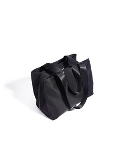 Close-up detail shot of the durable black nylon tote bag, showcasing sturdy straps and zippers.