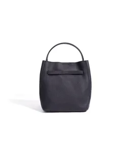 Detailed view of women genuine leather bucket bag, minimalist casual shoulder crossbody handbag.