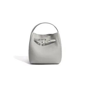 Grey leather bucket bag detail featuring top handle, chic silver lock hardware, and minimalist design.