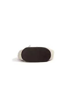 Detail view showing the oval bottom and linen genuine leather patchwork of the casual handbag.