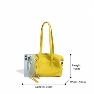 Vista detallada del bolso de mano amarillo de cuero genuino con dimensiones y diseño.