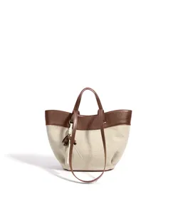 Detailed view of the linen and top-layer cowhide tote bag, featuring a stylish basket design.