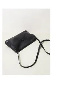 Minimalist black leather crossbody bag detail, premium casual shoulder handbag for women.