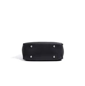 Detailed view of the black leather handbag bottom featuring protective silver metal feet.