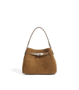 Brown suede handbag detail, metal turn-lock closure, retro design, elegant daily accessory.