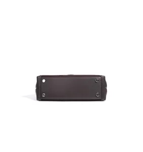 Detailed bottom view of the brown structured women handbag featuring protective metal feet.