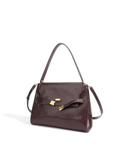 Vue détaillée du sac à main en cuir verni bordeaux de luxe avec de belles ferrures dorées.