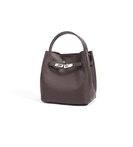 Dark brown leather bucket bag with metal lock detail, elegant everyday shoulder handbag.
