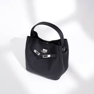 Minimalist black leather bucket bag with top handle and chic twist-lock hardware.