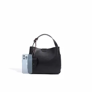 Black leather bucket bag for women, stylish minimalist shoulder bag with large daily capacity.