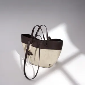 Stylish canvas and leather tote bag, elegant commuter handbag with large capacity and chic design.