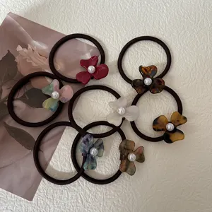 Elegant acetate flower hair ties with pearl accent, chic pony tail holders for women and girls daily wear.