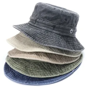 Detailed view of stacked washed cotton bucket hats in multiple colors, soft outdoor casual wear.