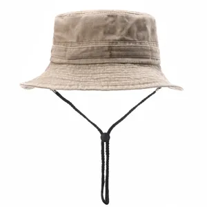Detailed view of khaki washed cotton bucket hat with black adjustable chin cord for outdoor sun.