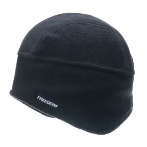 Detail view of the black winter fleece beanie, featuring warm windproof fabric and a label.