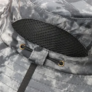 Close-up detail of camouflage bucket hat showing mesh vent, metal eyelets and drawstrings.
