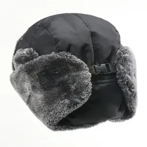 Detail shot of black winter trapper hat with soft grey faux fur earflaps and adjustable buckle strap.