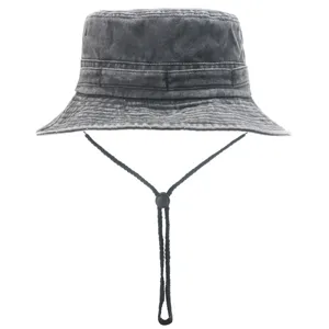 Detail view of black washed cotton bucket hat, featuring wide brim and adjustable chin strap.