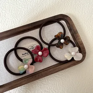 Chic acetate flower hair ties with pearl center, elegant vintage hair scrunchies for women.
