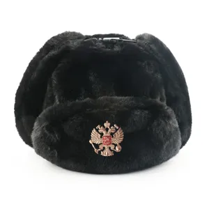 Detailed view of the black faux fur ushanka hat with warm earflaps and metallic emblem.