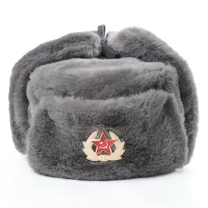 Close-up detail of the grey faux fur ushanka winter hat showing thick plush texture and badge.